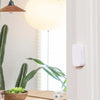 Xiaomi Aqara smart home security door and window sensor with ZigBee wireless connection installed on door frame