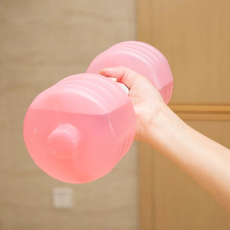 Pink water dumbbell held in hand for adjustable weight fitness training