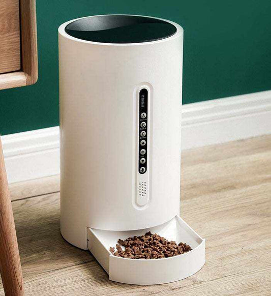 white smart pet feeder with digital display and food tray filled with pet kibble