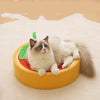 Cute cat lying on orange sisal velvet cat scratch board shaped like a fruit slice on beige carpet