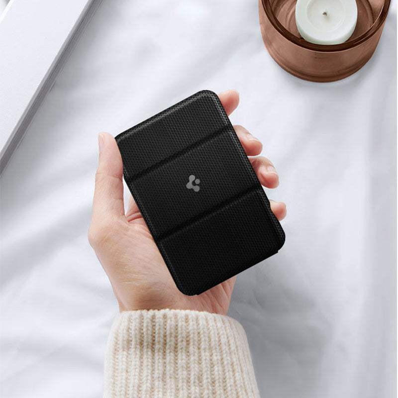 black magnetic card holder for iPhone held in hand with textured surface