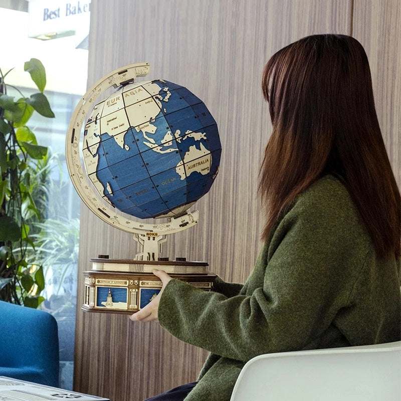 Robotime Globe Earth 3D wooden puzzle globe model held by person