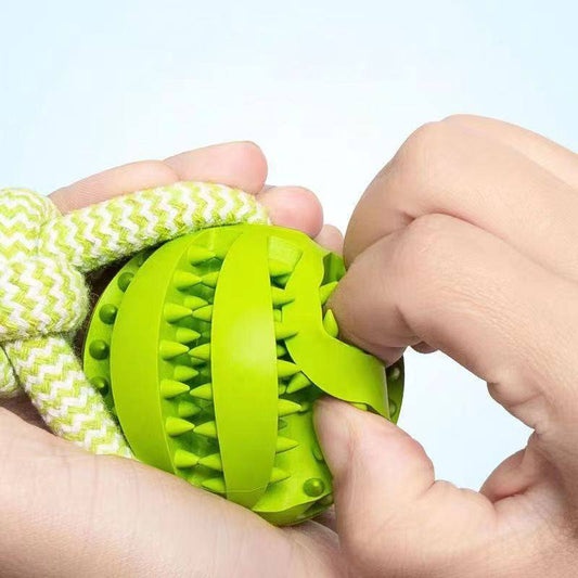 Green rubber dog treat ball with hemp rope for chewing and interactive play
