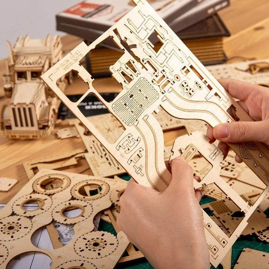Hands assembling 3D wooden puzzle pieces for a car model toy kit