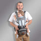 Man wearing grey ergonomic baby hip seat carrier with toddler facing forward