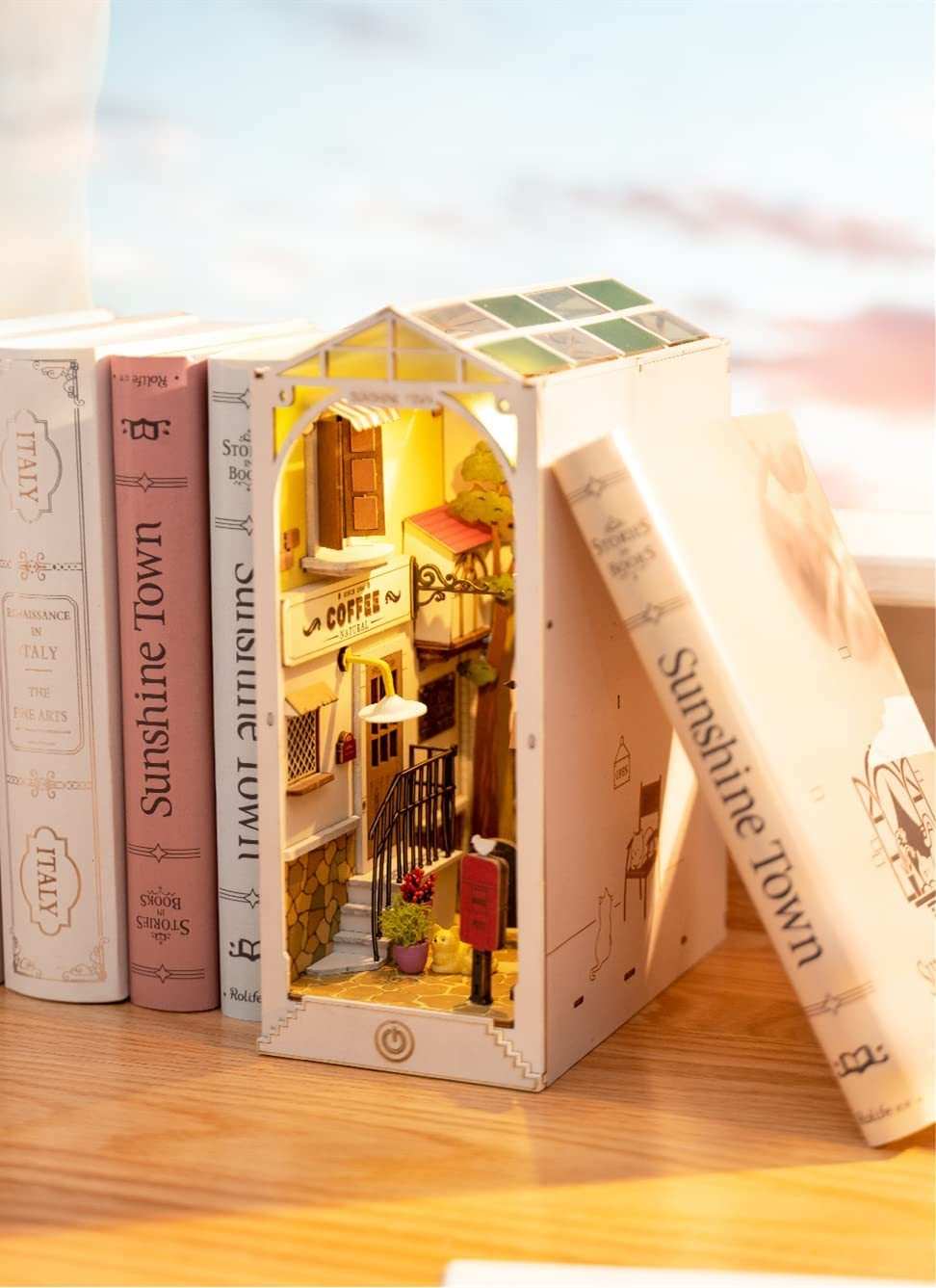 Robotime Rolife Book Nooks miniature wooden Sunshine Town DIY house furniture display between books on a shelf