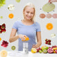 Woman using DIY automatic facial fruit vegetable mask maker with fresh fruits around for skin rejuvenation