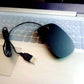 Black ultra-slim optical wired mouse with scroll wheel and USB 2.0 connector on laptop keyboard
