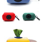 Compact Pet Supplies Stool Bag Dispenser in various colors made of durable diving fabric with a clip for easy carrying