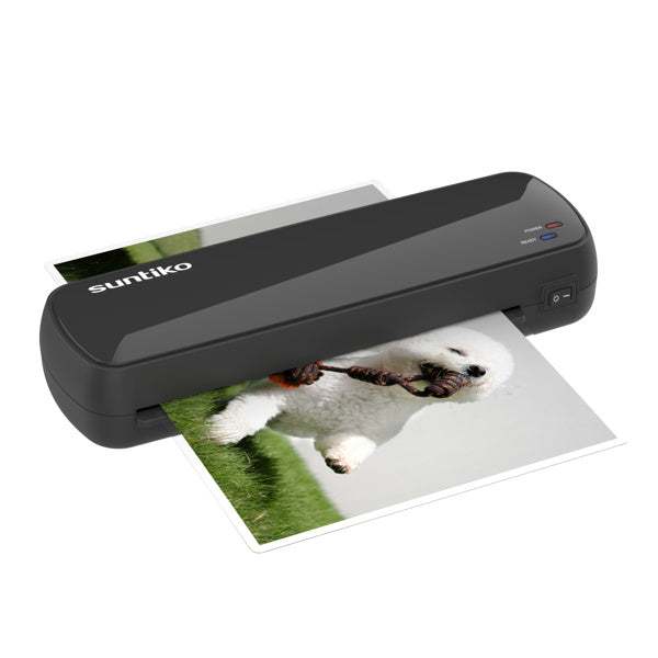 Compact black 4-in-1 laminating machine laminating a photo of a dog on grass with fast warm-up and jam-free design