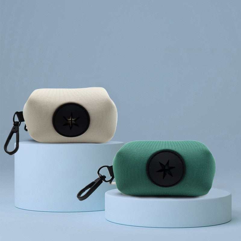 Pet supplies stool bag dispenser in white and green with clip for easy attachment