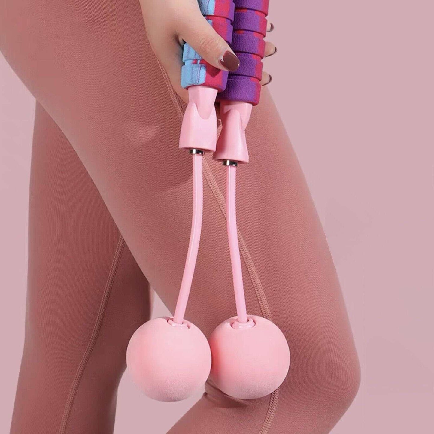 Adjustable weighted ropeless jump rope with pink handles and weighted balls for fitness workouts