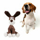 Dog playing with brown and white plush squeaky dog toy for chew and teeth cleaning