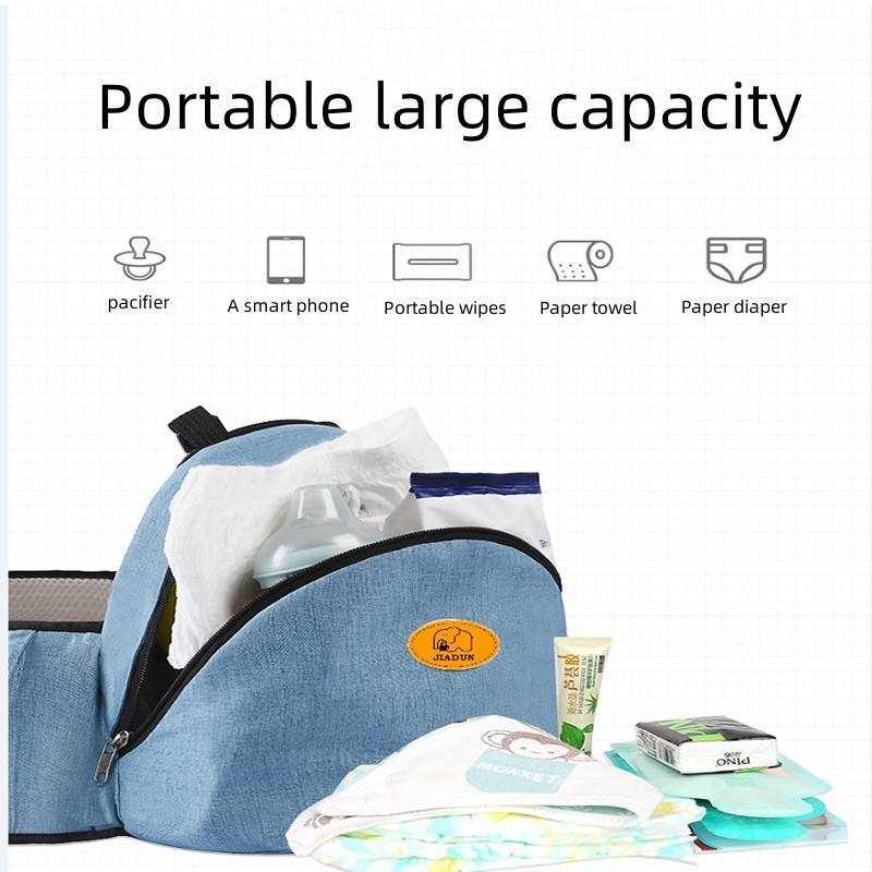 Blue baby hip seat carrier with large storage pouch holding pacifier, smartphone, wipes, towels, and diapers
