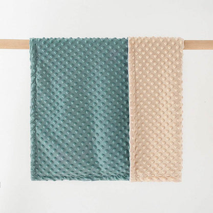Super soft double-layer baby blanket with dotted backing in teal and beige colors, perfect for newborns and toddlers.