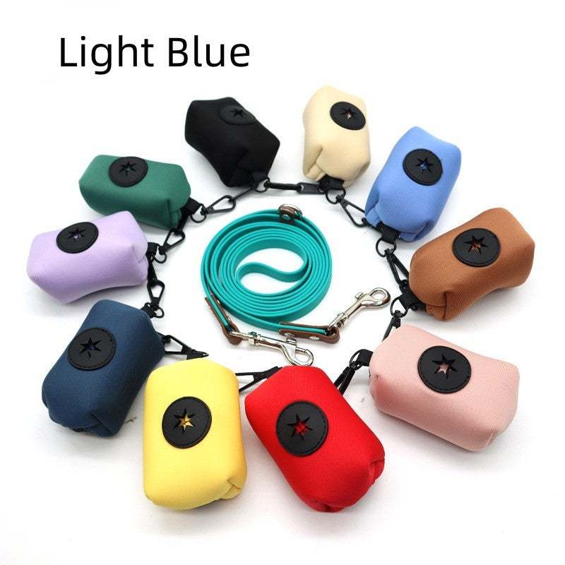 Colorful pet supplies stool bag dispensers in various colors arranged in a circle with a light blue leash in the center