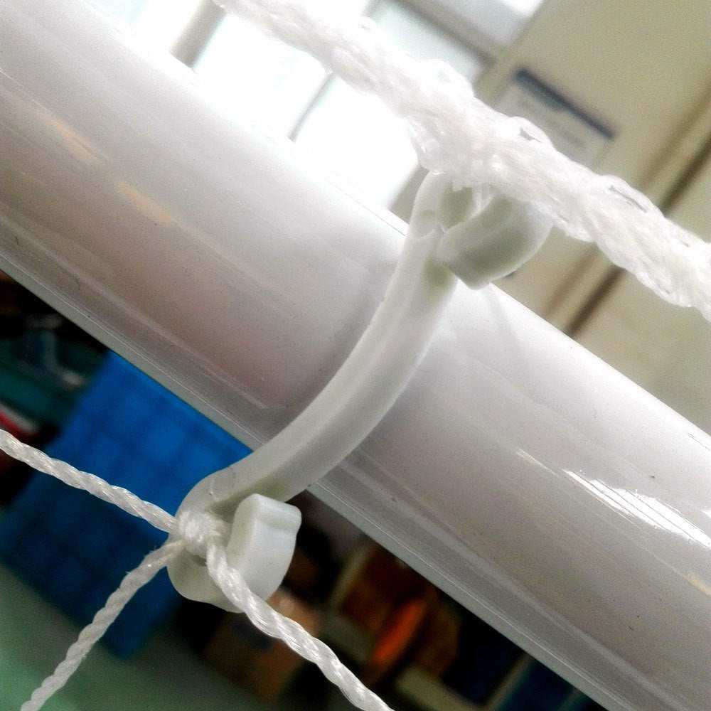 Close-up of net buckle securing white nylon net to powder coated steel tube of 8' x 5' soccer goal frame