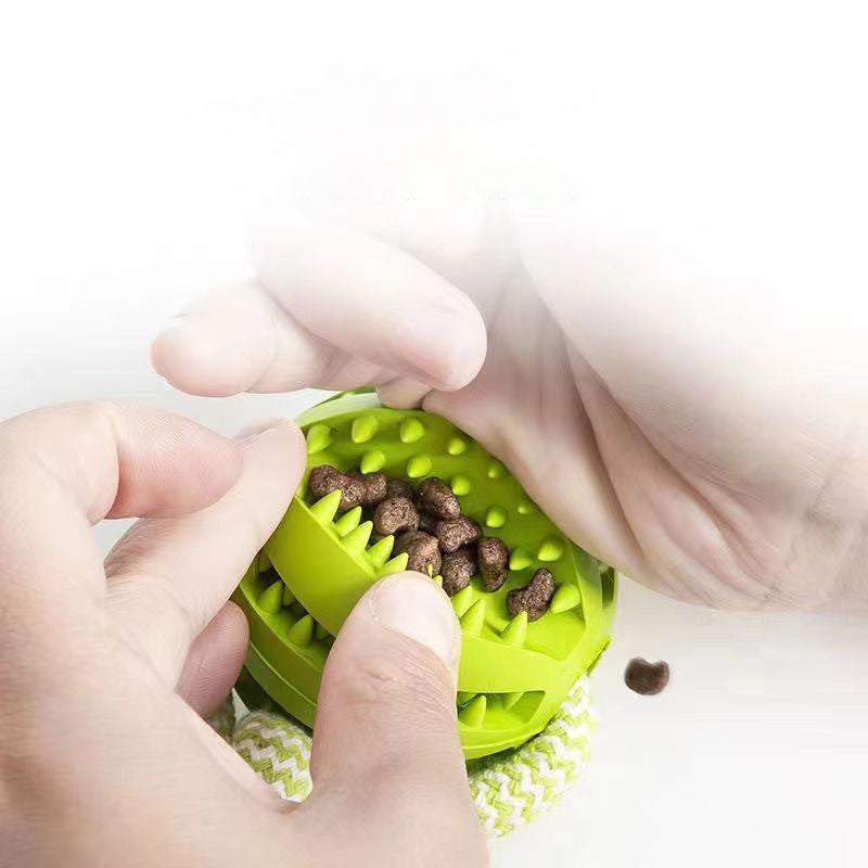 Interactive green dog treat ball with chewing teeth cleaning surface and hemp rope for small dogs